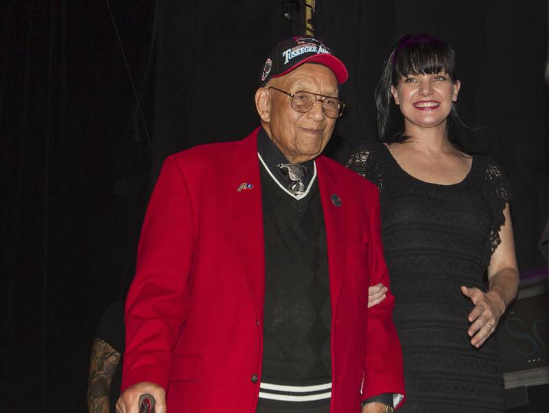 actress Pauley Perrette, right, and Lt. Col. Bob Friend, a Tuskegee Airman, stand onstage during the 2nd Annual Heroes Helping Heroes Benefit Concert