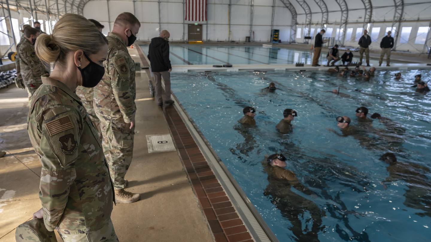 U.S. Air Force Maj. Gen. Michele Edmondson, 2nd Air Force commander, and Chief Master Sgt. Adam Vizi, 2nd Air Force command chief, survey 350th Special Warfare Training Squadron students performing water confidence training at Chaparral Pool at Joint Base San Antonio-Lackland, Texas, Jan. 21, 2022. Leaders from 2nd Air Force, the 17th Training Wing, 81st Training Wing and 82nd Training Wing gathered at the Special Warfare Training Wing to observe how the SW Training Group and Human Performance Support Group leverage technological advances and research to advance the training process. (Nicholas J. De La Pena/Air Force)
