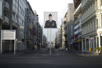 In this June 9, 2020, file photo, a picture of a former American soldier is displayed at the former U.S. Army Checkpoint Charlie in Berlin, Germany.