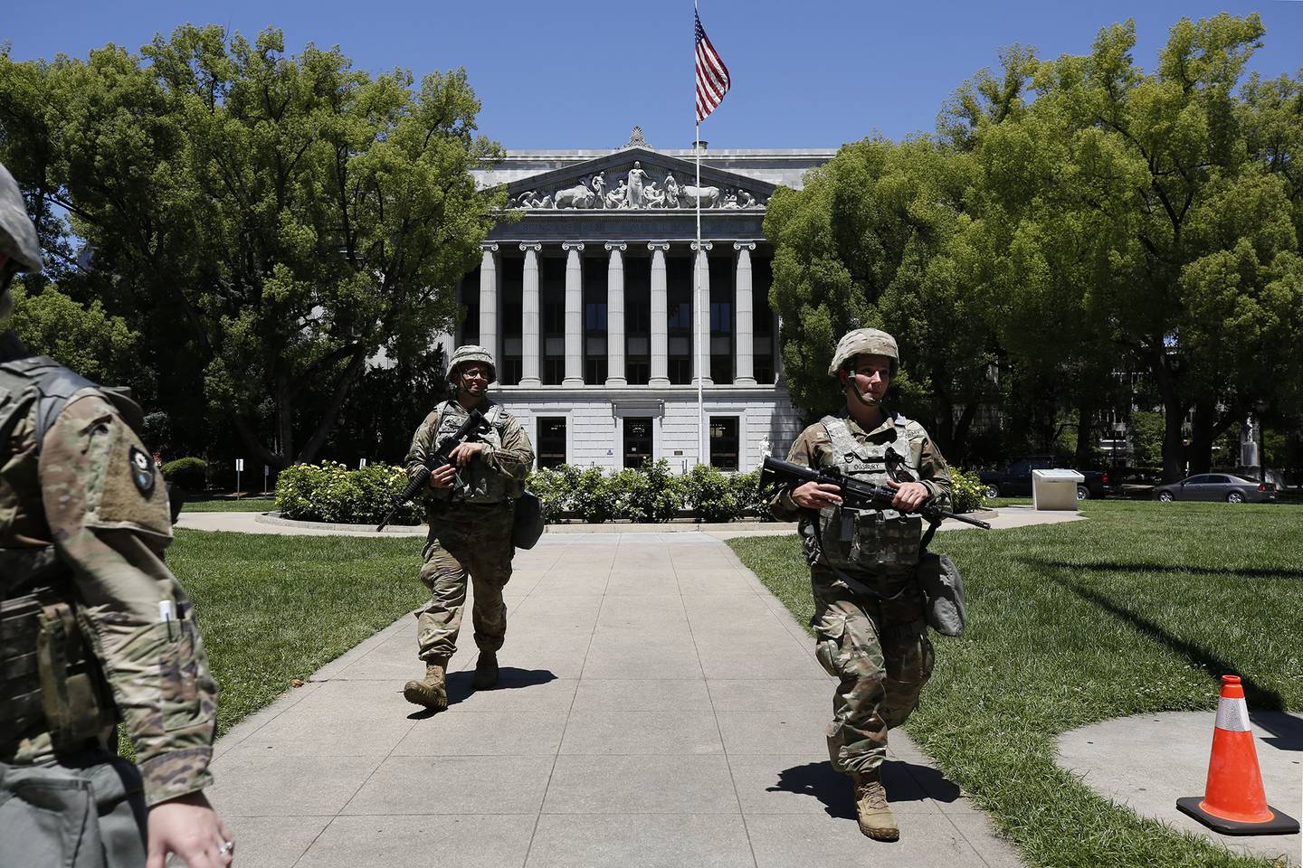 Members of the California National Guard walk the grounds near the Jesse M. Unruh State Office building in Sacramento, Calif., Tuesday, June 2, 2020.