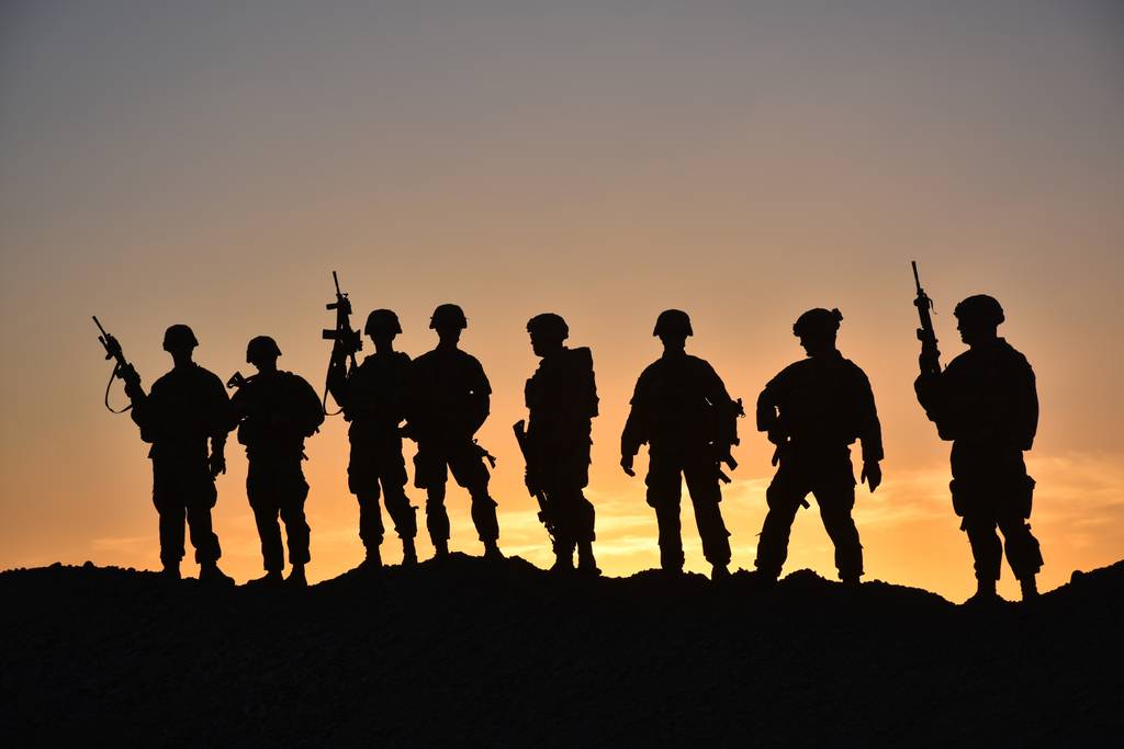 Soldiers pose for a group photo, March 28, 2018, in a post in the outskirts of Afghanistan.