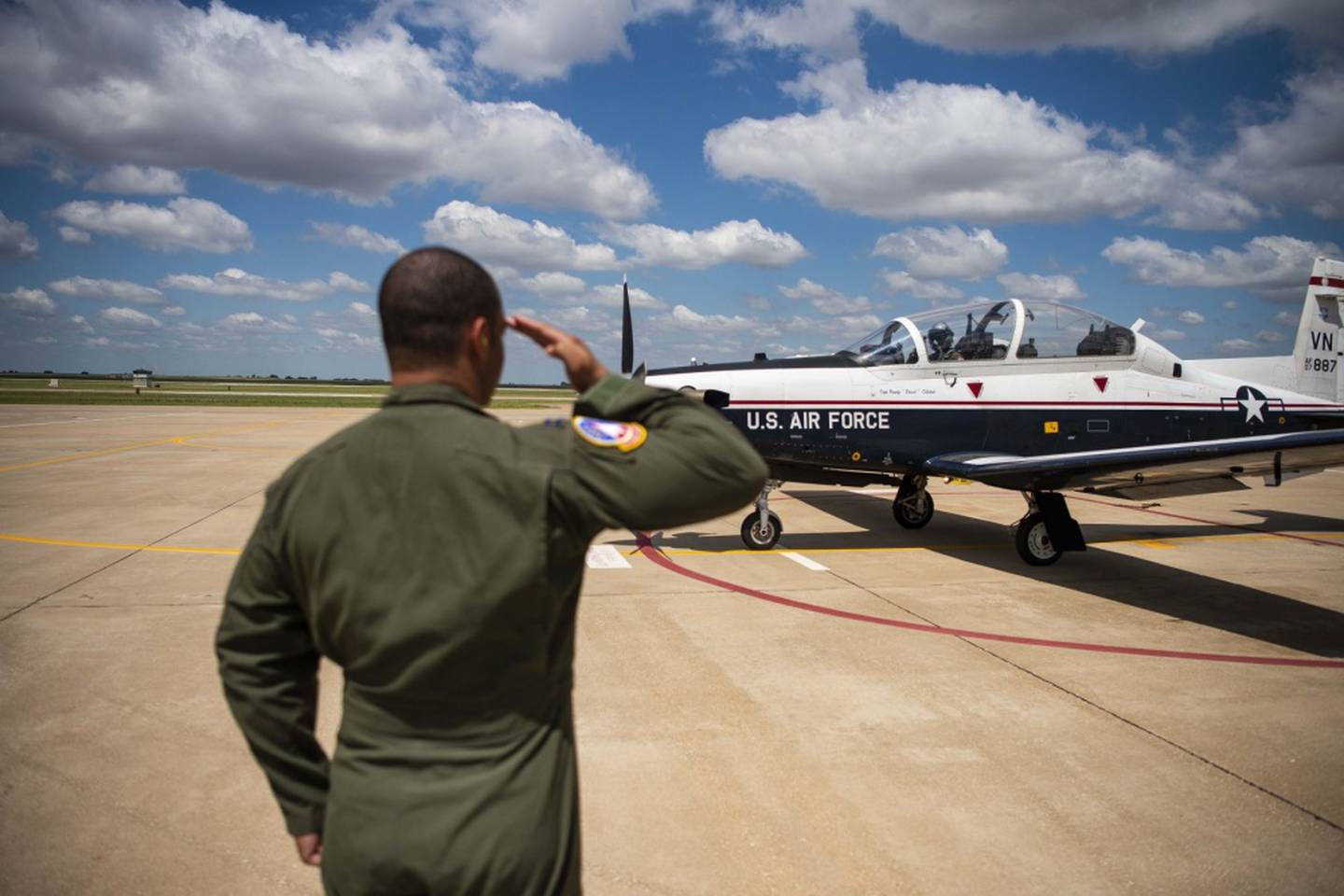 Capt. Marcel Trott, a flight commander assigned to the 71st Student Squadron, salutes 2nd Lt. Corey Persons, a student pilot assigned to the 71st SS, before his solo flight July 15, 2019, at Vance Air Force Base, Oklahoma. (Air Force/SrA Taylor Crul)