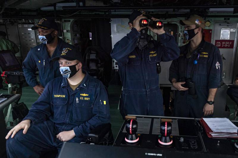 Sailors stand watch on the navigation bridge aboard the Freedom-variant littoral combat ship USS Detroit (LCS 7) as the ship pulls into Colon, Panama, on May 19, 2020, for stores and fuel.