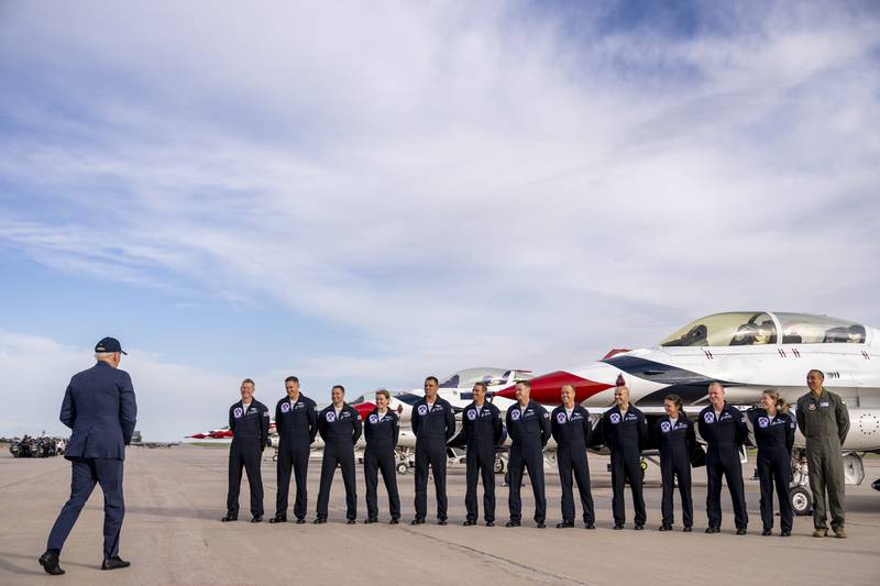 President Joe Biden greats a group of Thunderbird pilots after arriving at Peterson Space Force Base in Colorado Springs, Colo., Wednesday, May 31, 2023.