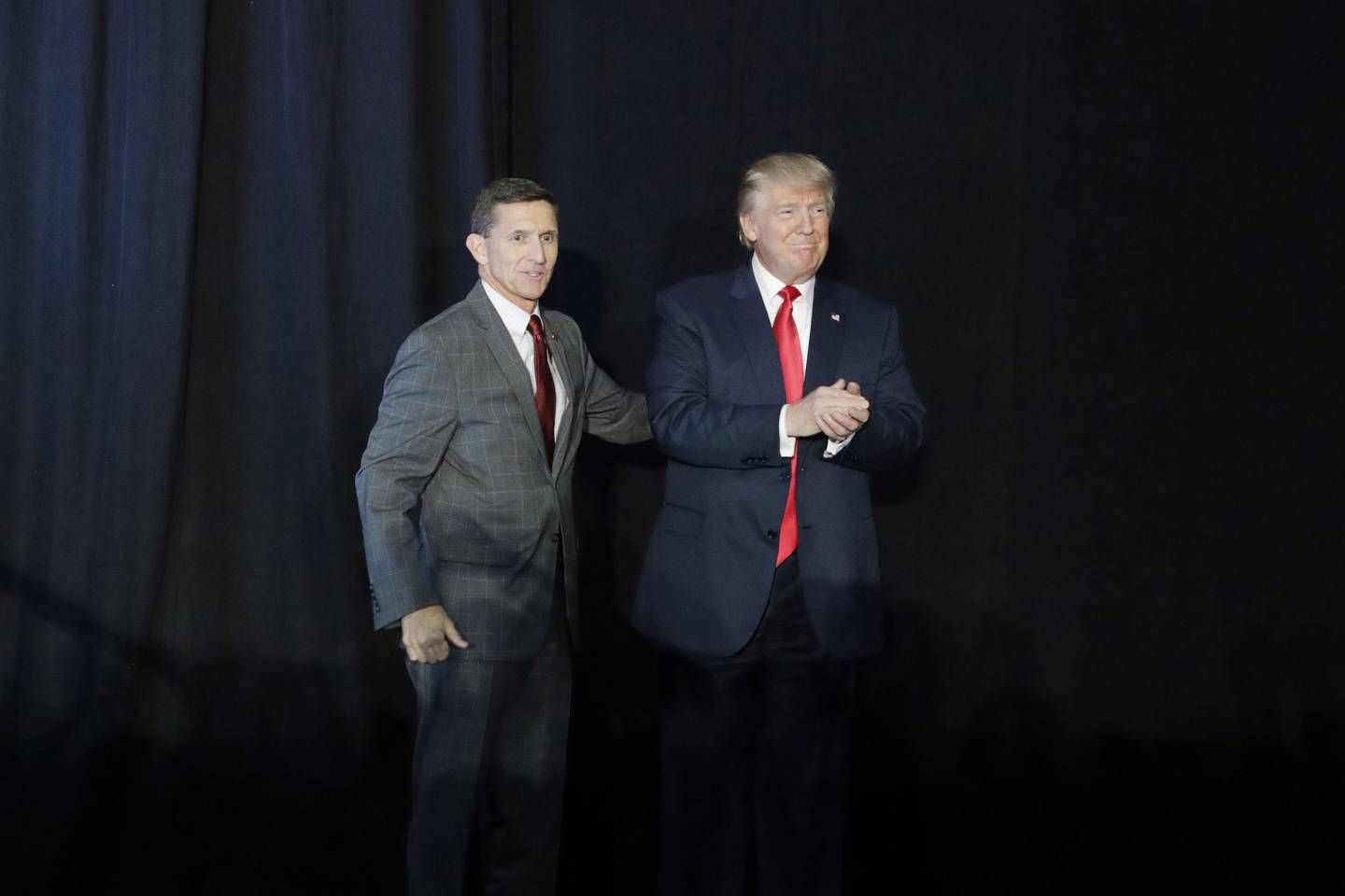 Retired Lt. Gen. Michael Flynn, left, introduces Republican presidential candidate Donald Trump at a campaign rally on Sept. 29, 2016, in Bedford, N.H.