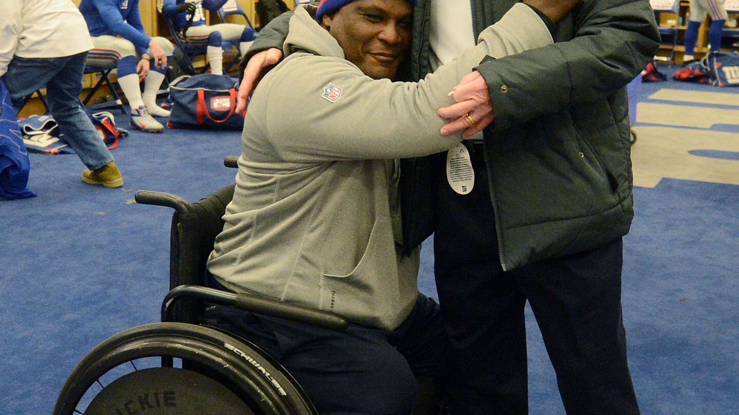 Giants Coach Tom Coughlin and Greg Gadson embrace in the team locker
room following a victory against the Green Bay Packers in November 2012. Coughlin had asked Gadson to be honorary co-captain in the game against the Packers for the 2007 NFC Championship. (Photo by Evan Pinkus, owned exclusively
by and reproduced with the permission
of New York Football Giants, Inc.)