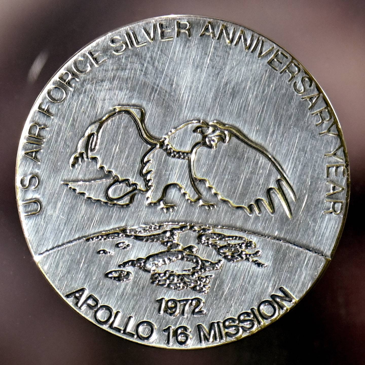 This commemorative medallion was taken to the moon by U.S. Air Force Colonel Charles M. Duke, Jr., Lunar Module Pilot for the Apollo 16 mission. A second, duplicate coin was left at the Descartes moon site by Duke in commemoration of the Silver Anniversary of the Air Force. The medallion, a moon rock and a flag were presented to the Air Force on July 13, 1972 by Duke. (Ty Greenlees/Air Force)