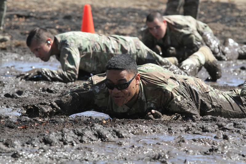 U.S. Army Sgt. Miguel Leyua of the California National Guard’s 330th Military Police Company, 143rd Military Police Battalion, 49th Military Police Brigade, one of the cadres of the 49th’s 2020 Best Warrior Competition, low crawls through a mud pit during the competition, Aug. 8-12, 2020 at Camp Roberts, Calif.