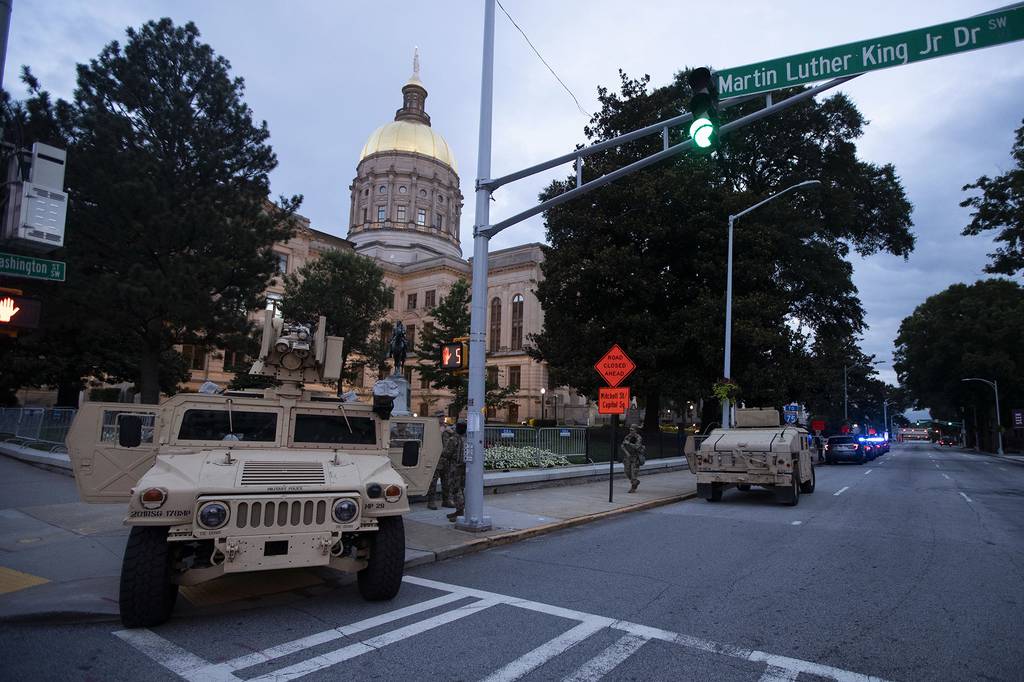Members of the Georgia National Guard stand outside the State Capitol on July 7, 2020, in Atlanta.