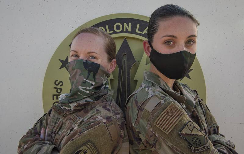 Air Force Capt. Monica Clements, and Air Force Staff Sgt. Heather Fejerang pose for a photo, June 30, 2020, at Al Udeid Air Base, Qatar.