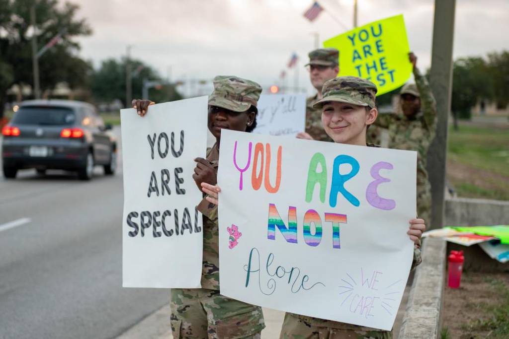 U.S. Air Force Senior Airman Piketinal Alou, left, and Airman 1st Class Destiny Story, 502d Comptroller Squadron, hold positive messages of support at base gates during the morning inbound commute as part of their on-going initiative, “We Care,” at JBSA-Lackland, Texas, Sept. 16, 2022. They spent the morning at various gates letting each person know that the simple, yet powerful display allows for everyone to stand together in support of those struggling with depression and thoughts of suicide. (Thomas Coney/Air Force)