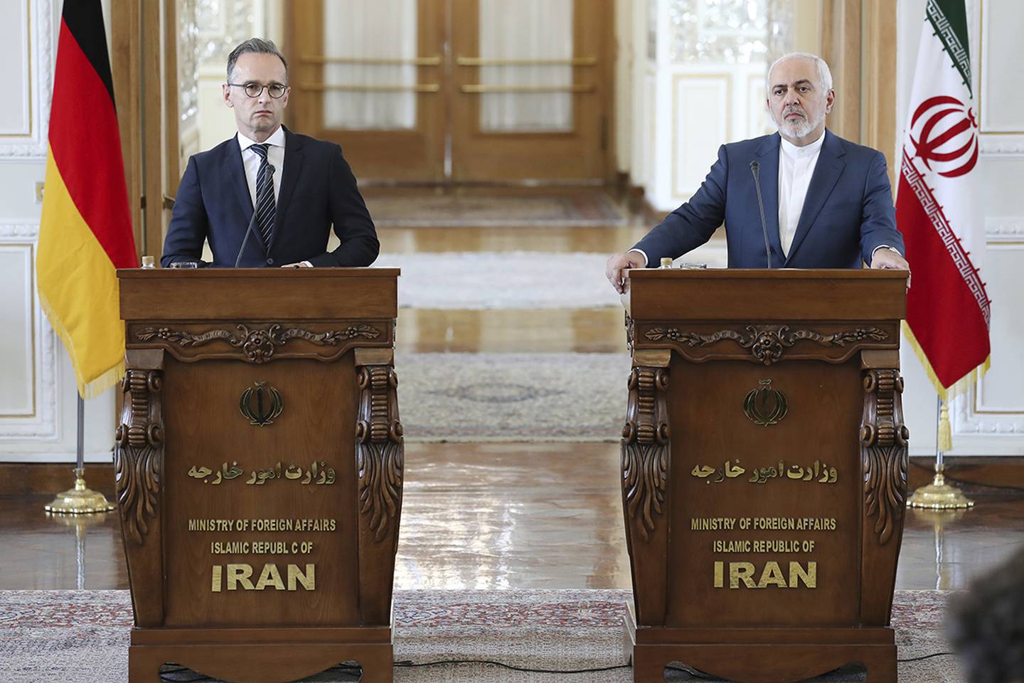Iranian Foreign Minister Mohammad Javad Zarif, right, and his German counterpart Heiko Maas give a press conference after their talks