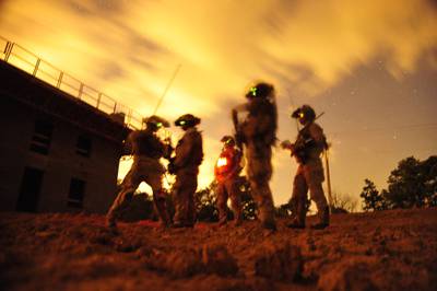 In this 2012 photo made available by the U.S. Navy, a squad of Navy SEALs participate in special operations urban combat training at an undisclosed location.
