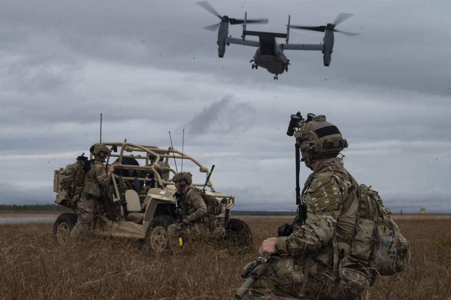 Special tactics operators assigned to the 23rd Special Tactics Squadron, watch a CV-22 Osprey tilt-rotor aircraft assigned to the 8th Special Operations Squadron, take off from the Eglin Range Complex, Florida, Dec. 8, 2021. (Tech. Sgt. Carly Kavish/Air Force)