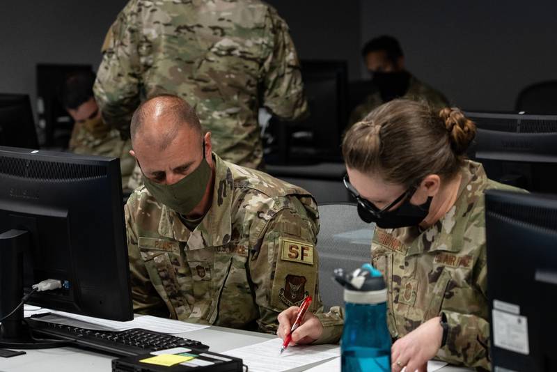 Chief Master Sgt. Robert Plant, superintendent of the 919th Special Operations Security Forces Squadron, and Chief Master Sgt. Christina Bicknell, chief of the 919th Special Operations Mission Support Group, reviews an enlisted performance report during training for raters at Duke Field, Fla., April 9, 2021. (Senior Airman Dylan Gentile/Air Force)