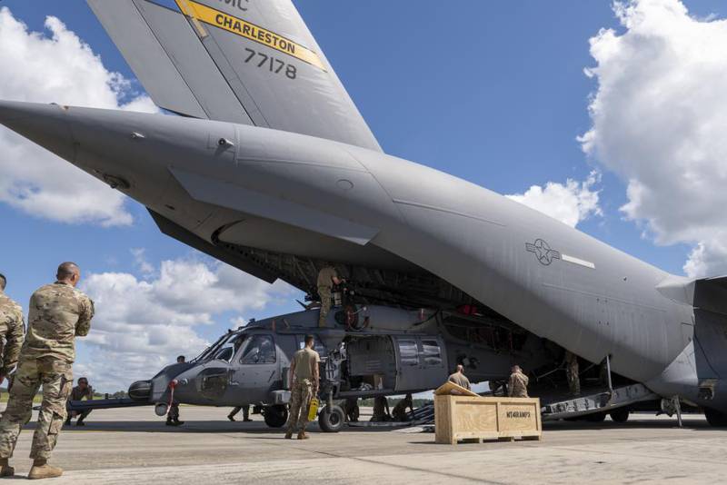U.S. Air Force airmen assigned to the 23rd Wing load an HH-60W Jolly Green II combat search-and-rescue helicopter onto a C-17 Globemaster III at Moody Air Force Base, Georgia, Sept. 19, 2022. This is the first deployment for the HH-60W. It offers a range of improved capabilities over its predecessor, including improved range and survivability. (Airman 1st Class Deanna Muir/Air Force)
