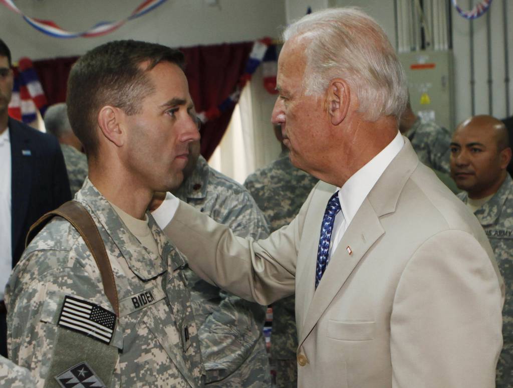 In this July 4, 2009, file photo, then-Vice President Joe Biden, right, talks with his son, Army Capt. Joseph R. "Beau" Biden III, at Camp Victory on the outskirts of Baghdad, Iraq.