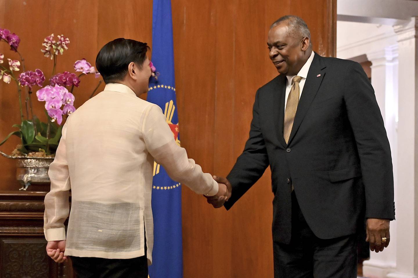 U.S. Secretary of Defense Lloyd James Austin III, right, shake hands with Philippine President Ferdinand Marcos Jr. during a courtesy call at the Malacanang Palace in Manila, Philippines on Thursday, Feb. 2, 2023.