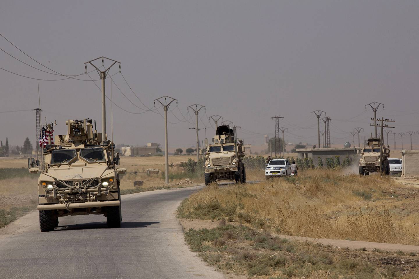U.S. armored vehicles travel in a joint patrol of the safe zone between Syria and the Turkish border with the Tal Abyad Military Council Tal Abyad, Syria, Friday, Sept. 6, 2019.