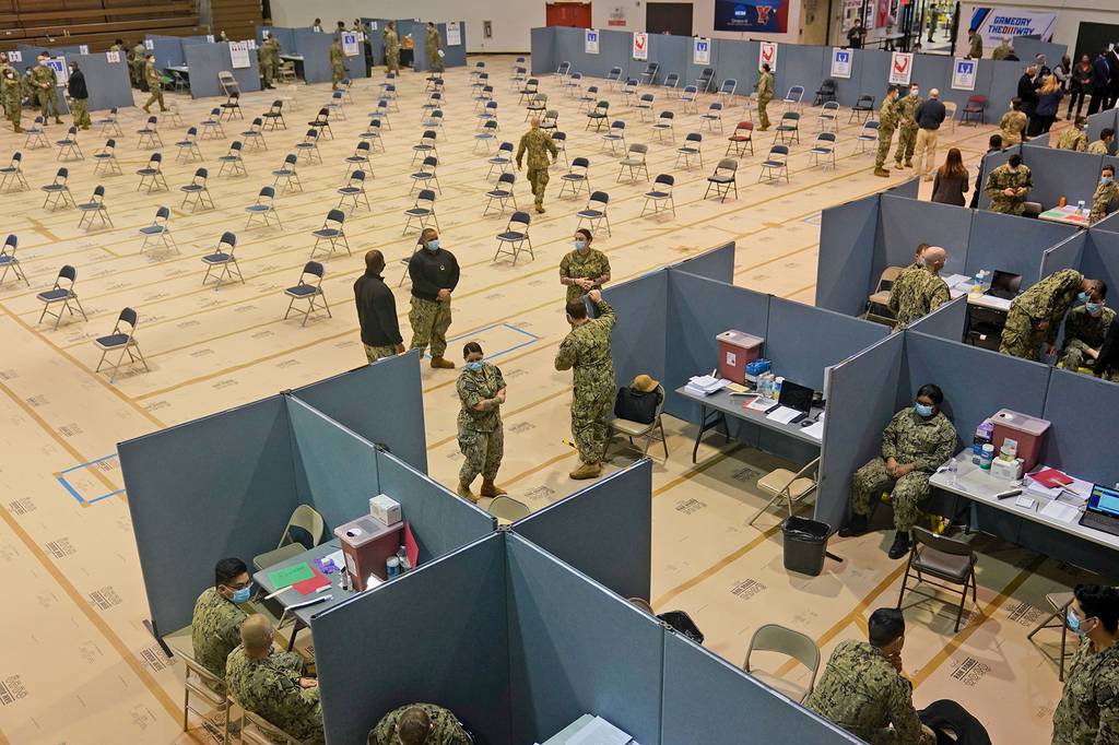 Military personnel prepare for the opening of a mass Covid-19 vaccination site in the Queens borough of New York on Feb. 24, 2021.