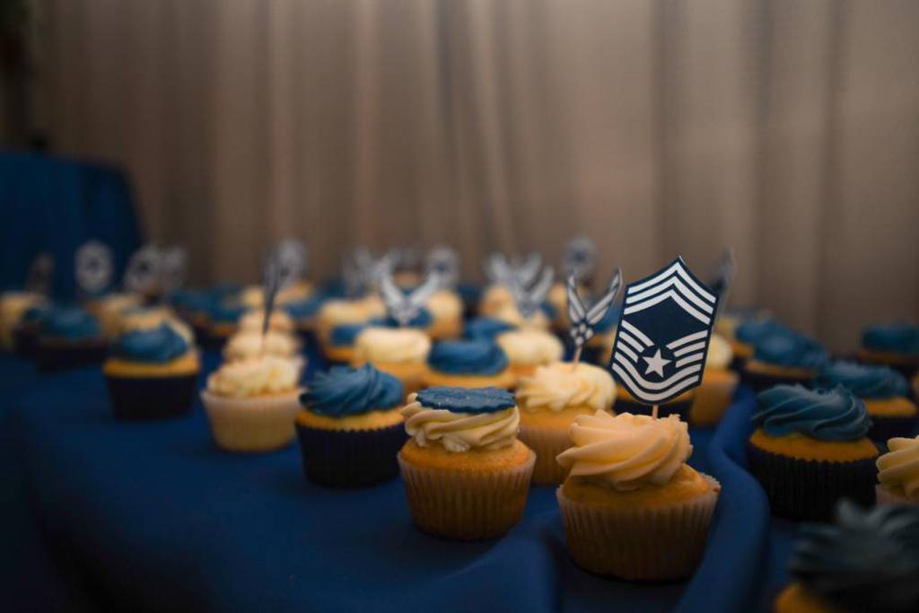 A cupcake with the chief master sergeant insignia sits on a decorative snack table during a ceremony at Martin’s Crosswinds in Greenbelt, Md., March 18, 2022. During the ceremony, 34 service members were promoted, putting them in the 1% of airmen to reach chief master sergeant. (Airman 1st Class Bridgitte Taylor/Air Force)