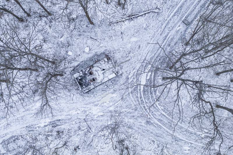 A destroyed Russian tank covered in snow stands in a forest in the Kharkiv region of Ukraine on Saturday, January 14, 2023.