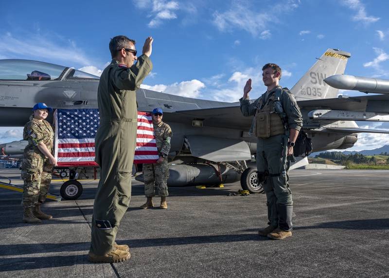 U.S. Air Force Maj. Joseph Butters administers the oath of office to U.S. Air Force Captain Devin Mulvanny during a promotion ceremony during Exercise Relampago VI at Comando Aereo de Combate Number 5 in Rionegro, in Colombia, July 19, 2021. (Senior Airman Duncan Bevan/Air Force)