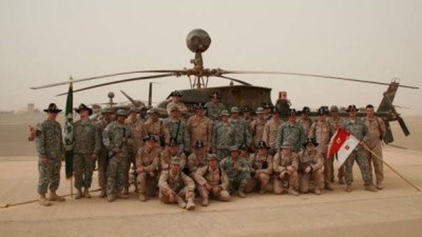B 3-17 CAV, 10th Mountain Division, stand in front of an OH-58D the day before they fly into Baghdad, Iraq during the 2008 surge. (Photo courtesy of B.B. Sanders)