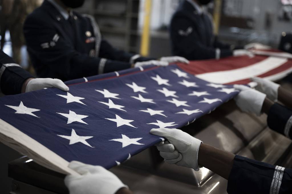 Ceremonial Guardsmen of the Base Honor Guard fold the American flag during a practice exercise at Little Rock Air Force Base, Ark., Aug. 25, 2020.