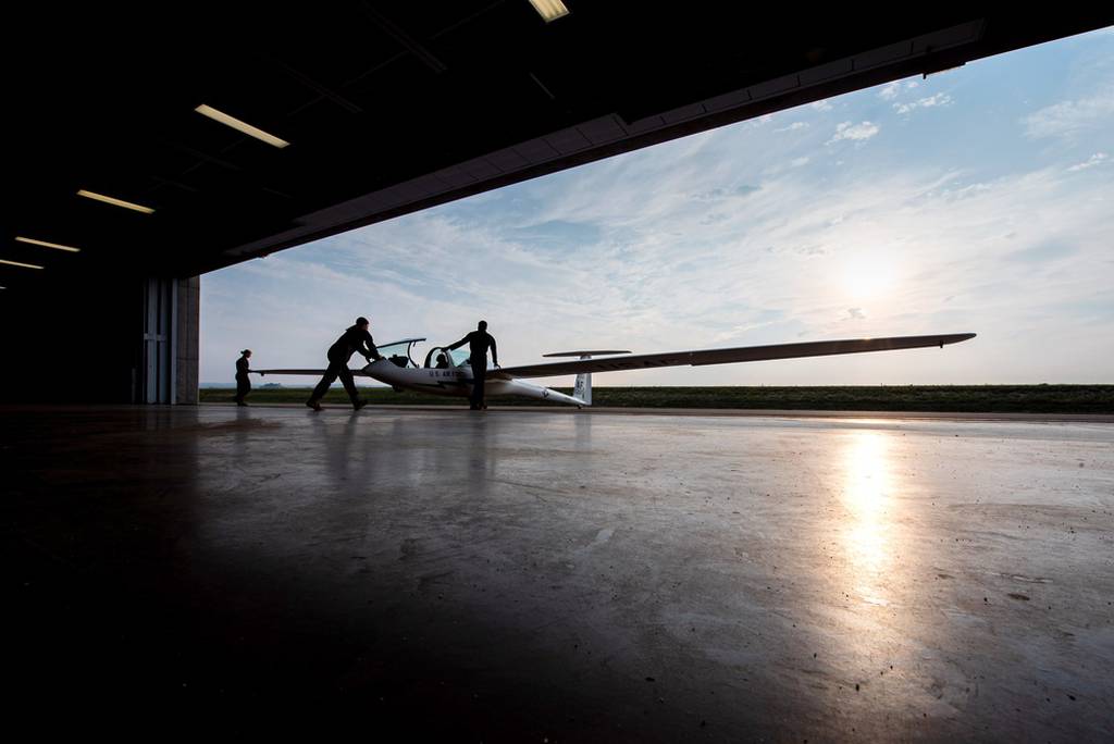 U.S. Air Force Academy cadets push a glider out of the academy's midfield hanger before taking flight in the Soaring program at Davis Airfield in Colorado Springs, Colo., on Aug. 10, 2021. (Trevor Cokley/Air Force)