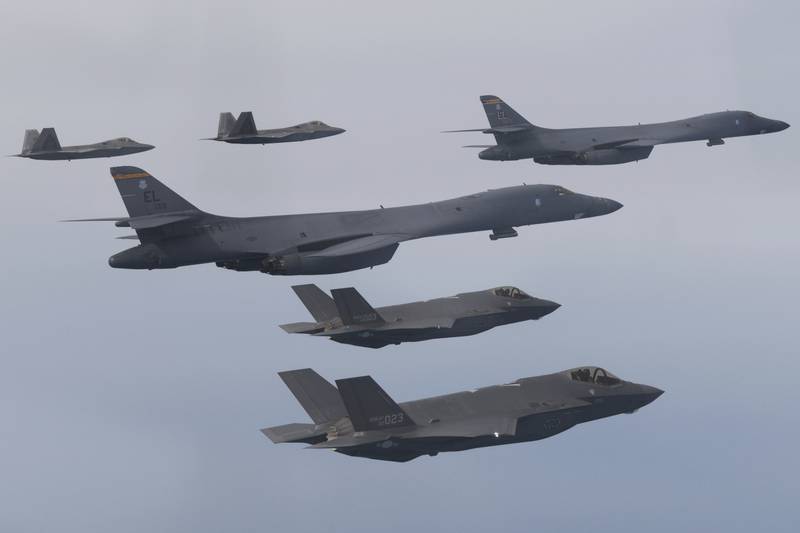 In this photo provided by South Korean Defense Ministry, U.S. Air Force B-1B bombers, center, F-22 fighter jets and South Korean Air Force F-35 fighter jets, bottom, fly over South Korea Peninsula during a joint air drill in South Korea, Wednesday, Jan. 1, 2023.
