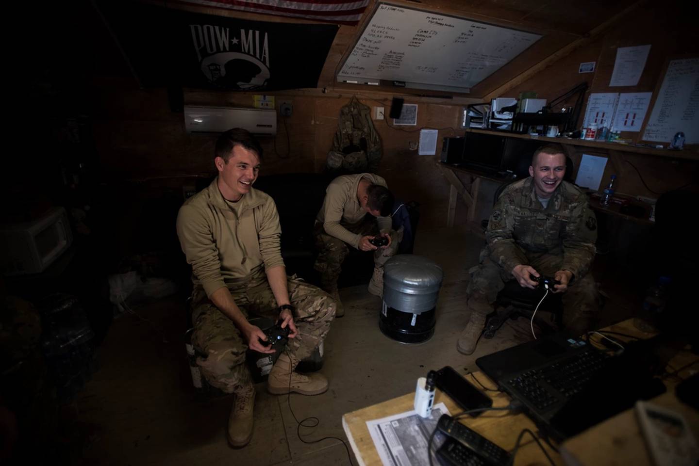 Senior Airman Domynic Panto and Tech. Sgt. Bob Kaster, 455th Expeditionary Aircraft Maintenance Squadron communications, navigation and mission systems technicians, and Airman 1st Class Mitchell Dillon, 455th EAMXS electronic warfare combat systems technician, play video games at Bagram Air Base, Afghanistan, Jan. 12, 2017. (Staff Sgt. Katherine Spessa/Air Force)