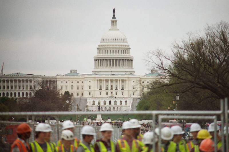 The Capitol Dome in Washington, D.C., is seen in April 2024 behind a construction crew and fencing. This photo was taken using 35mm color film.