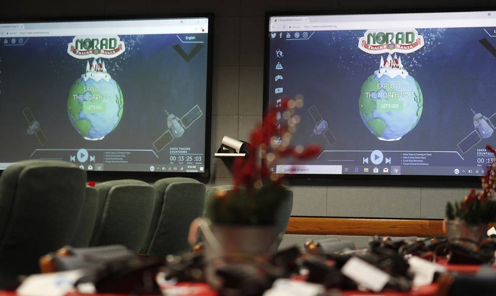 In this Dec. 23, 2019, file photo monitors are illuminated in the NORAD Tracks Santa center at Peterson Air Force Base in Colorado Springs, Colo.