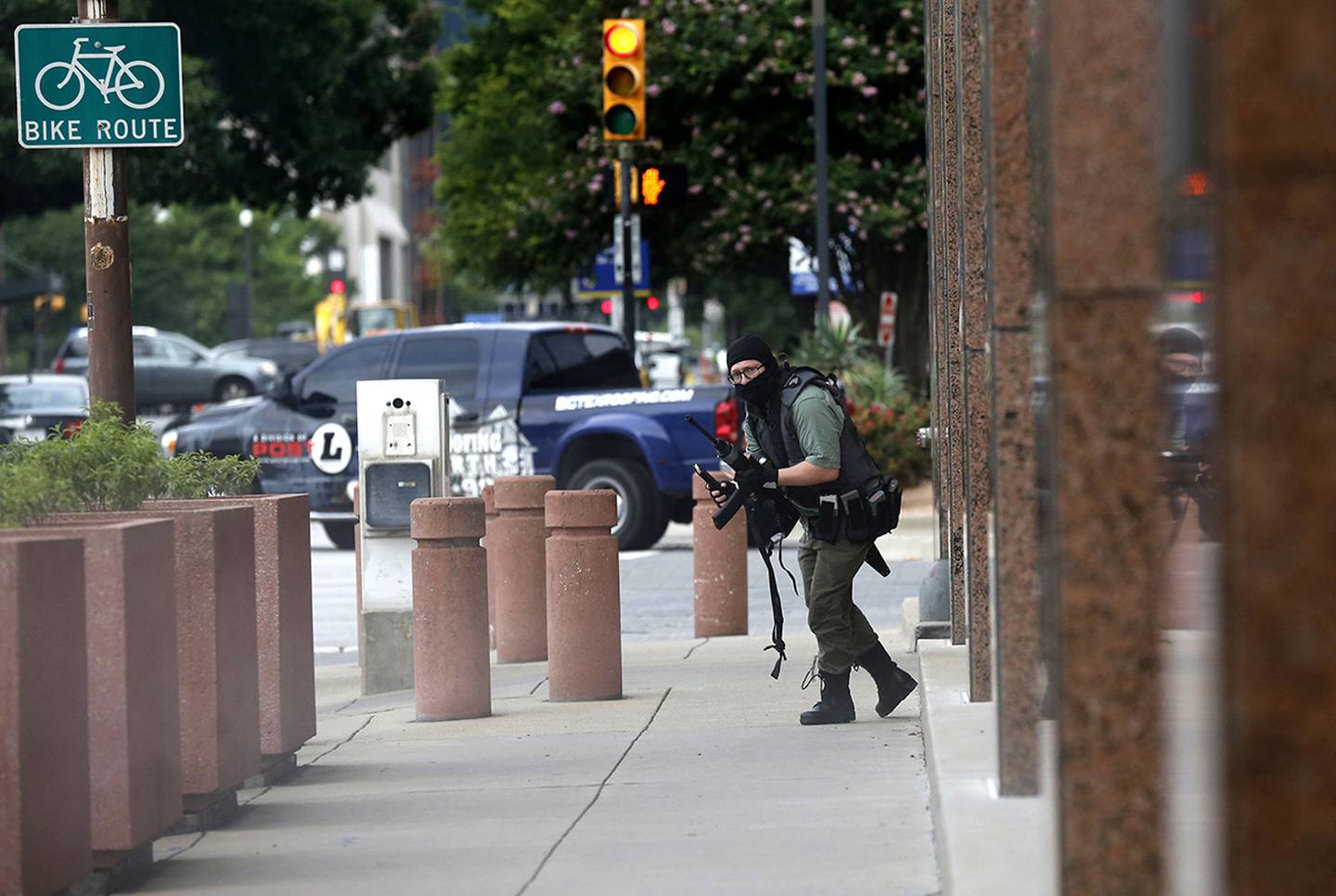 An armed shooter, identified as Brian Isaack Clyde, stands near the Earle Cabell Federal Building Monday, June 17, 2019, in downtown Dallas.