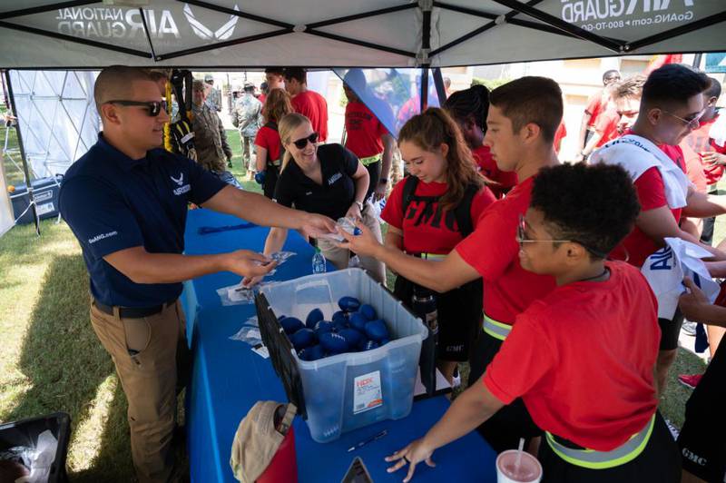Georgia Air National Guard recruiters interact with students at a football game