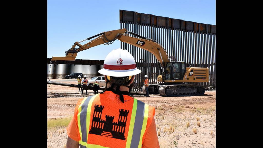 A U.S. Army Corps of Engineers South Pacific Border District employee views panel installation at the Yuma 2 border barrier project near Yuma, Ariz., May 21, 2020.