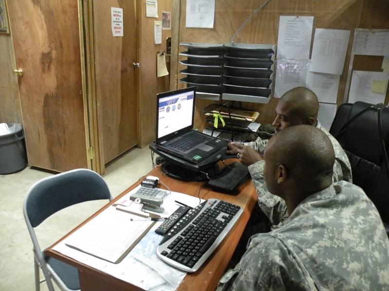 Sgt. Reginald Pearsall explains to Spc. Joshua Lewis on how his official military personal file is used to keep track of important documents such as enlistment and reenlistment contracts, awards, and military education on Oct. 3, 2008, in Baghdad, Iraq.