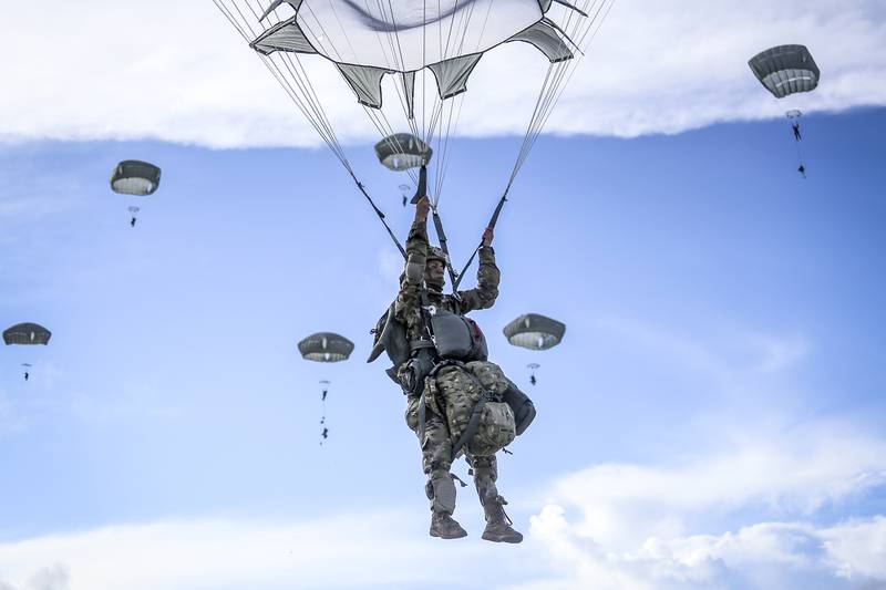 Paratroopers from the 4th Brigade Combat Team (Airborne), 25th Infantry Division, jump from a C-17 onto Andersen Air Force Base, Guam, on June 30 2020.