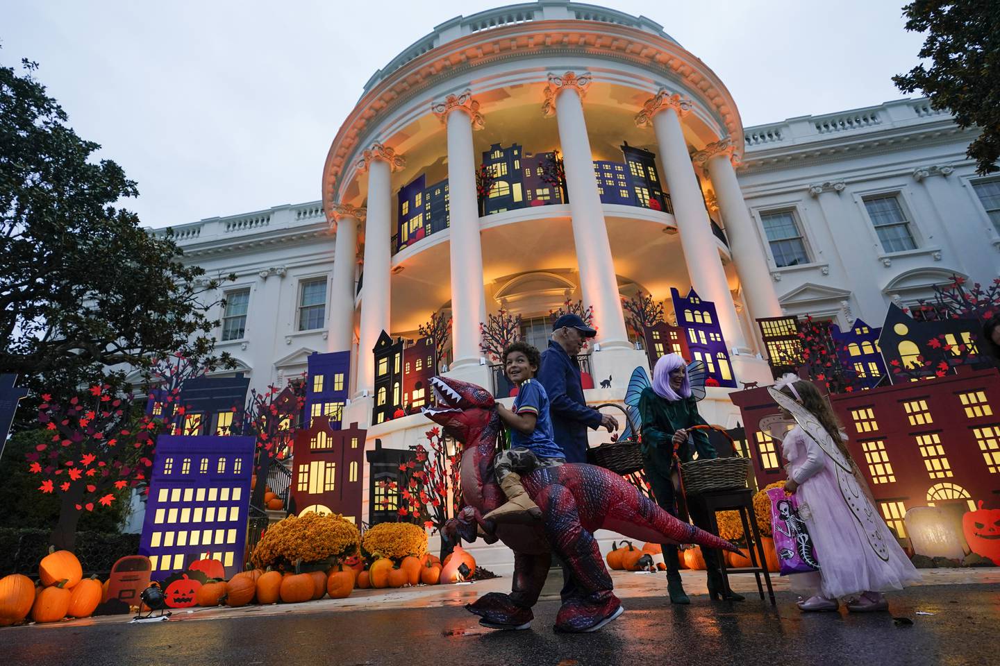 President Joe Biden and first lady Jill Biden give treats to trick-or-treaters on the South Lawn of the White House, on Halloween, Monday, Oct. 31, 2022, in Washington.