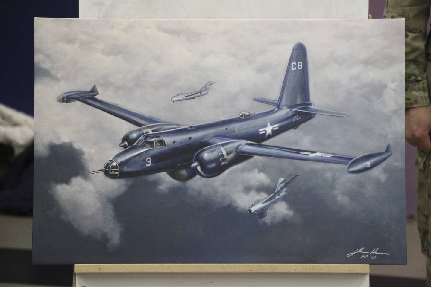 This March 28, 2023, photo shows a depiction by artist John Hume of the Navy Neptune that was shot down by Soviet MiG-15s on June 22, 1955, as displayed in Gambell, Alaska.