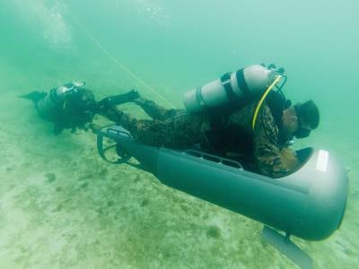 Marines with Force Reconnaissance Company, 3rd Reconnaissance Battalion, 3rd Marine Division, complete an open circuit dive during a Diver Propulsion Device certification course at Camp Schwab, Okinawa, Japan