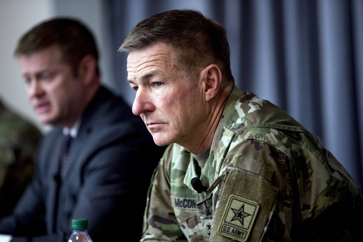 In this March 19, 2020, file photo Secretary of the Army Ryan McCarthy, left, accompanied by Gen. James McConville, Army chief of staff, right, speaks at a news conference at U.S. Army Medical Research and Development Command at Fort Detrick in Frederick, Md.