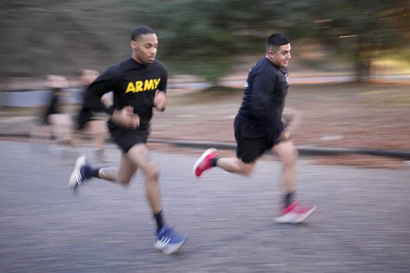 Army Staff Sgt. Daniel Murillo, right, runs up hill as part of his physical training at Ft. Bragg on Wednesday, Jan. 18, 2023, in Fayetteville, N.C.