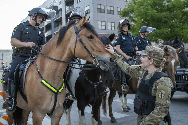 Soldiers with the Nebraska Army National Guard engage with Omaha Police Mounted Patrol Unit officers and their horses June 2, 2020, in downtown Omaha.