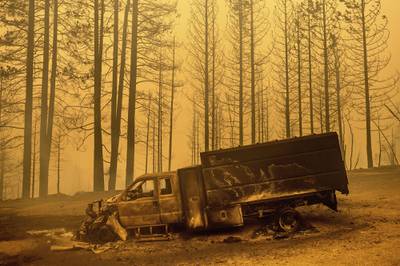 A scorched truck rests on Highway 168 after the Creek Fire burned through the area on Tuesday, Sept. 8, 2020, in Fresno County, Calif.