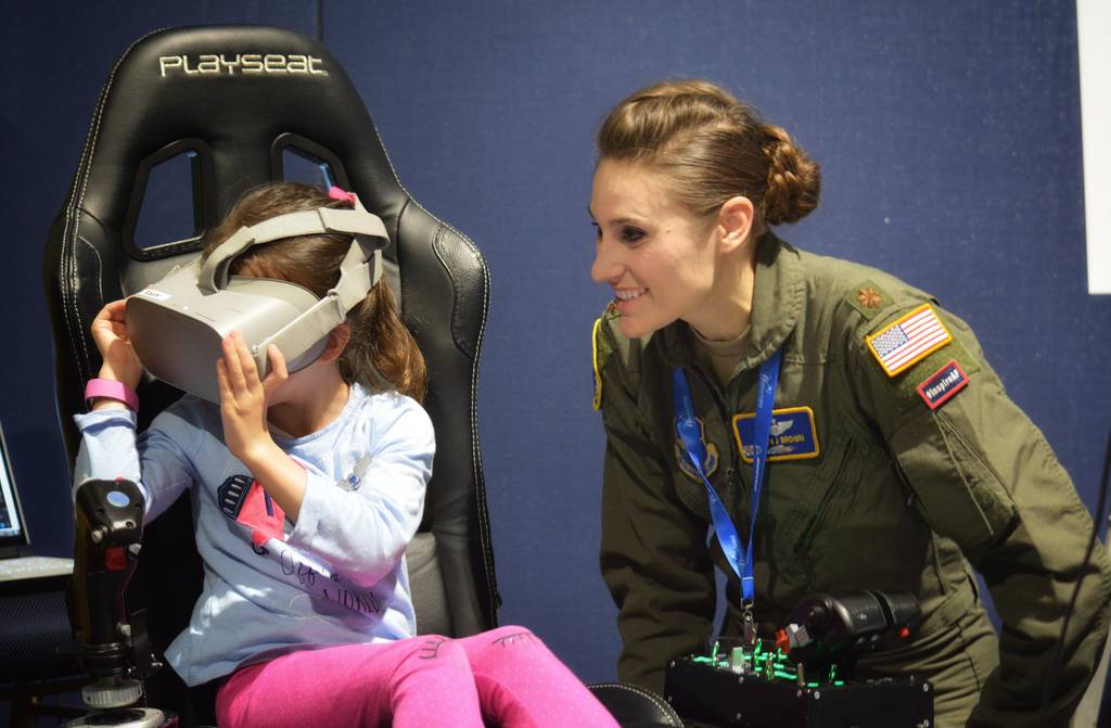 Maj. Afton Brown, Air Force Recruiting Service Detachment 1, assists a young aviator during the Girls in Aviation Day at the Women in Aviation International conference in Lake Buena Vista, Fla., March 7, 2020. (Christa D’Andrea/Air Force)
