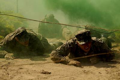 Special Warfare combatant-craft crewman candidates low-crawl under an obstacle during The Tour at Naval Special Warfare Center in Coronado, Calif., June 1, 2020.