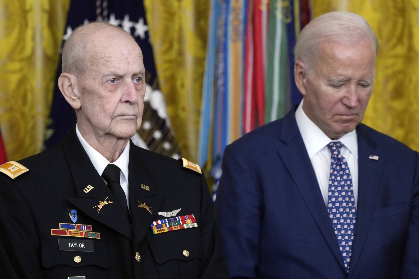 President Joe Biden listens to the citation being read before he awards the Medal of Honor to Capt. Larry Taylor, an Army pilot from the Vietnam War who risked his life to rescue a reconnaissance team that was about to be overrun by the enemy, during a ceremony Tuesday, Sept. 5, 2023, in the East Room of the White House in Washington.
