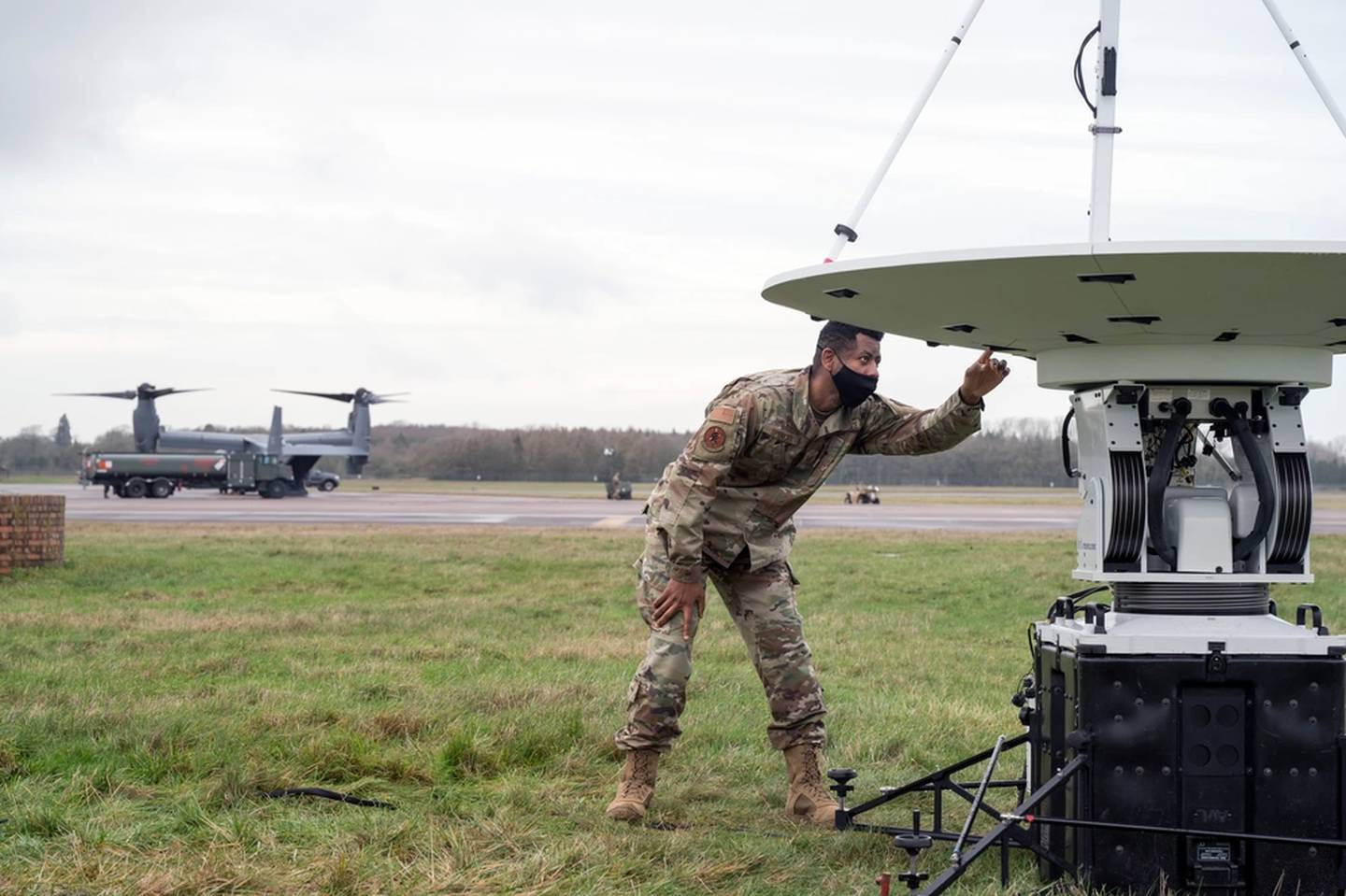 A 352nd Special Operations Support Squadron communications airman checks the connections to the unit's satellite link during exercise Epic Totem at RAF Fairford, United Kingdom, Jan. 11, 2022. The satellite is vital to communications, web and network usage of all personnel deployed from the 352nd Special Operations Wing. (Staff Sgt. Jeremy McGuffin/Air Force)